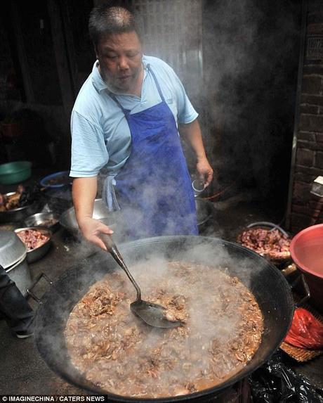 A real dogs dinner: A disturbing picture of a dog dish being prepared in China