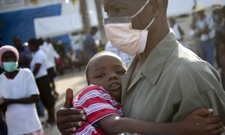A man and a boy wait for medical attention in Haiti as cholera sweeps the earthquake ravaged island