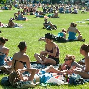 People soak up the sun _n Clapham Common, south London, as the UK experiences a weekend of hot weather