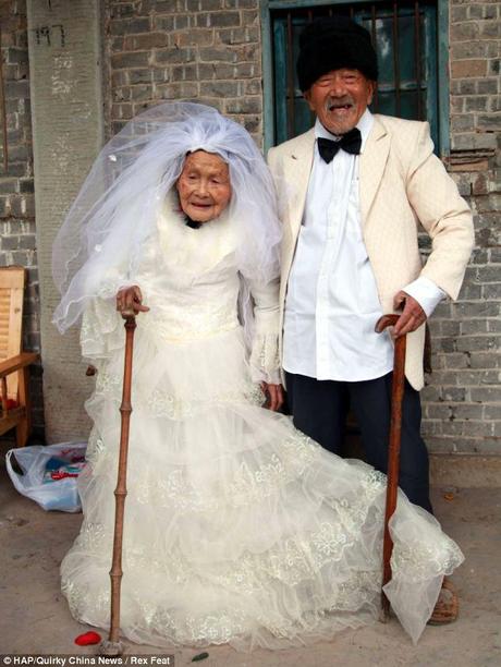 Never too late: Dressed in their finest wedding attire the 101-year-old groom and his 103-yerar-old bride pose for their photo - 88 years after the wedding