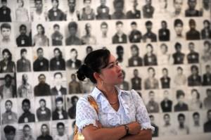 Thatcher Pol Pot Vietnam A Cambodian woman looks at portraits of