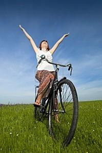 7199824-happy-young-woman-relaxing-over-a-vintage-bicycle.jpg