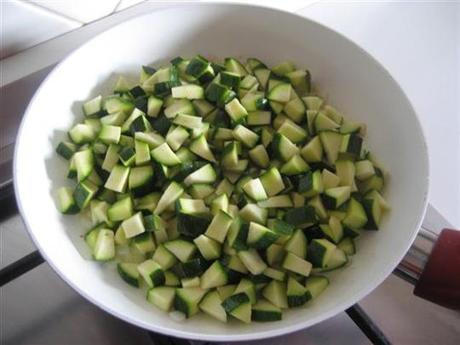 Lasciare leggermente imbiondire la cipolla tagliata a pezzetti nell'olio, aggiungere le zucchine precedentemente lavate e tagliate a dadini.