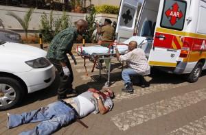 Rescuers attempt to evacuate a man injured in a shootout between armed men and the police at the Westgate shopping mall in Nairobi