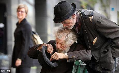 Just the job: Sir Ian McKellen and fellow Godot star Roger Rees  outside the theatre admiring their 'earnings'