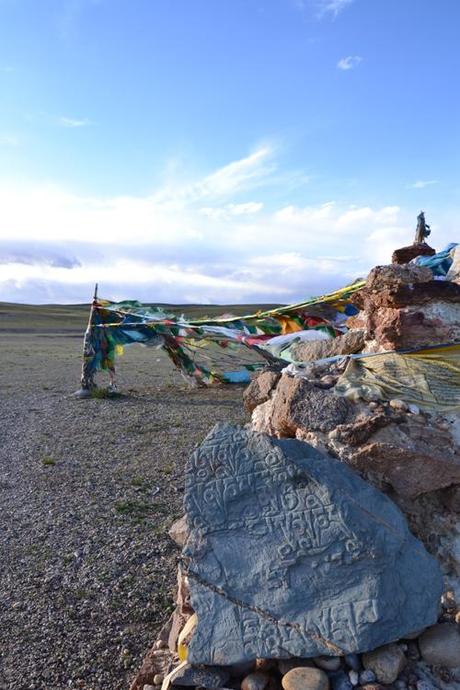 Mantra su roccia e su bandiere da preghiera. Zona del Lago Mansarovar, Tibet. Foto di Sonia Orazi