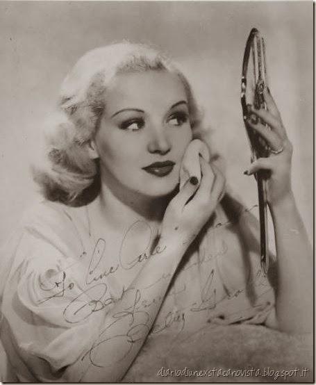 Betty Grable applying the finishing touches to her make-up