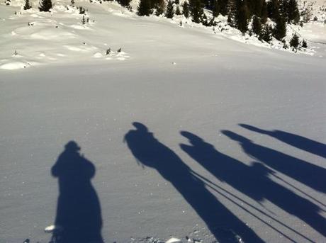 gruppo di ciaspolatori in sosta sotto il sole