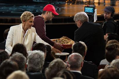 Host Ellen DeGeneres passes out pizza during the live ABC Telecast of The Oscars® from the Dolby® Theatre in Hollywood, CA Sunday, March 2, 2014.photo credit: Greg Harbaugh / ©A.M.P.A.S.