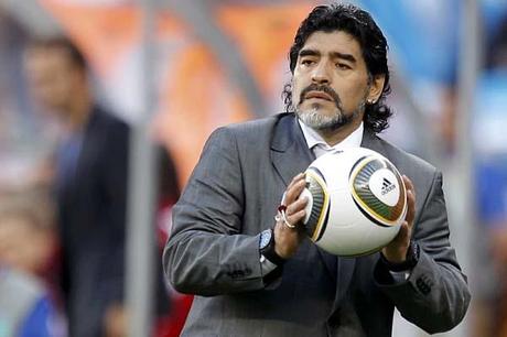 Argentina's coach Maradona holds onto the ball during their 2010 World Cup quarter-final soccer match at Green Point stadium in Cape Town