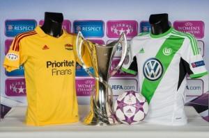 La coppa con le orecchie delle Women's Champions League tra le maglie delle due finaliste, Tyrëso e Wolfsburg
