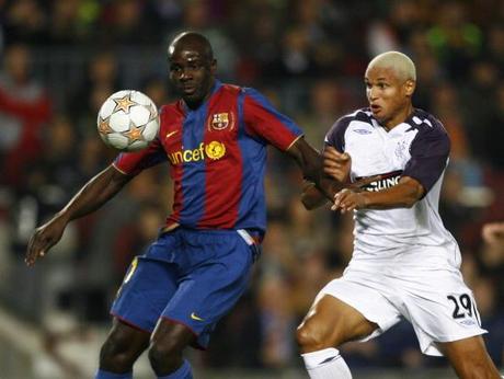 Barcelona's Lilian Thuram (L) holds off