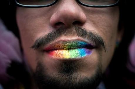 An attendee with rainbow-colored lips pauses during the annual gay pride parade in Sao Paulo June 10, 2012.