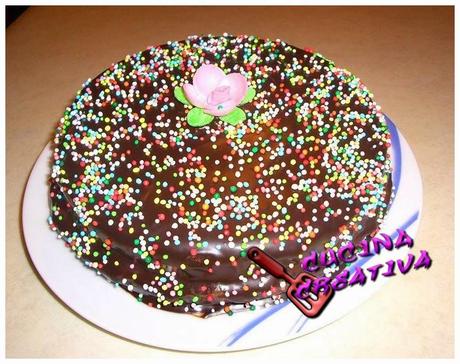 torta ricoperta do glassa al cioccolato e confettini colorati