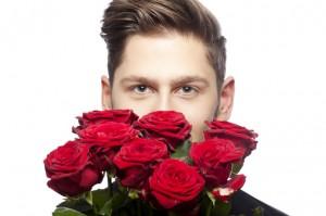 Young man offering roses