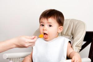 Happy baby spoon feeding