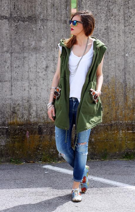 Outfit: Parka verde smanicato, ripped jeans e scarpe oxford con stampa fumetto