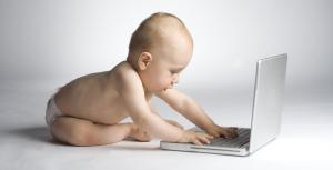 Toddler playing with laptop