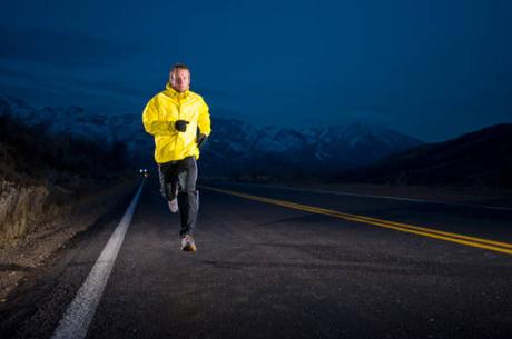 Man running on the road at night in Emigration Canyon near Salt Lake City, Utah
