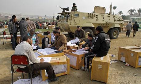 Egyptian officials count ballots at an open-air election centre in Cairo