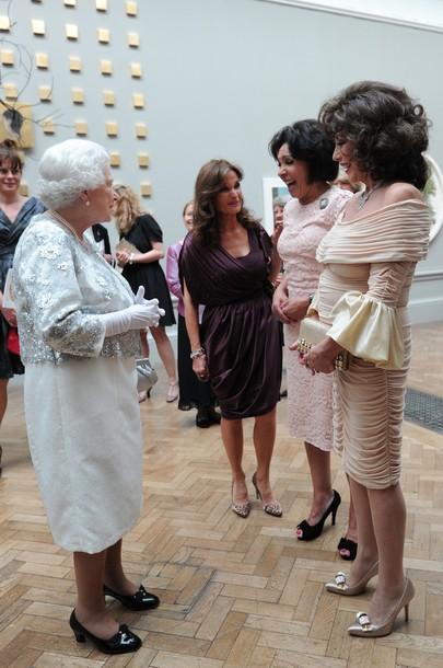 Actress Joan Collins (R), singer Shirley Bassey (C) and actress Kate O'Mara (L) meet Britain's Queen Elizabeth II during her visit to the Royal Academy of Arts in central London, on May 23, 2012.