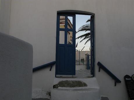 blue chaires in a white little nice square in Serifos
