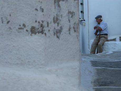 blue chaires in a white little nice square in Serifos