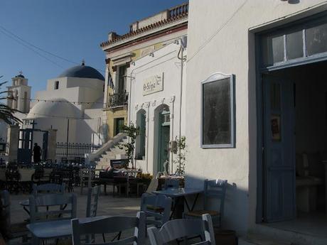 blue chaires in a white little nice square in Serifos