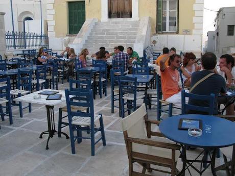 blue chaires in a white little nice square in Serifos