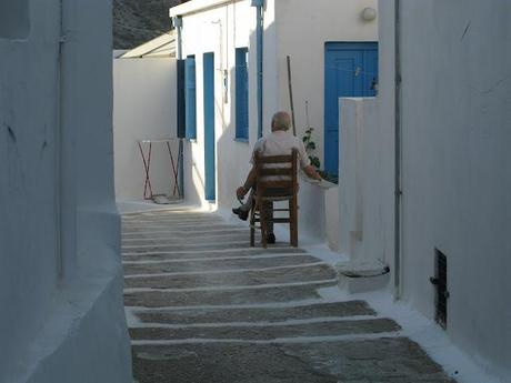 blue chaires in a white little nice square in Serifos