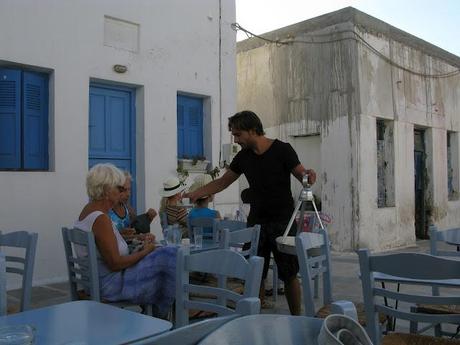 blue chaires in a white little nice square in Serifos