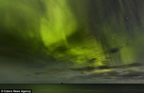 Hidden face: The green stretch of light could be confused for a cosmic invasion as it bizarrely resembles the face of the space creature