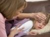 Mother Taking Temperature Of Sick Daughter