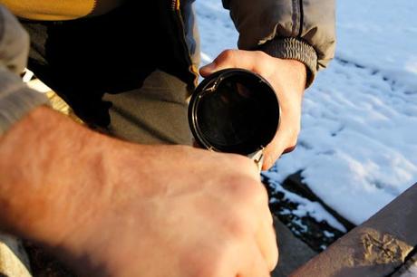 Salmon Arm, BC - Steps to remove a stuck lens filter: #4. Blow off glass/metal bits, then using pliers, bend/peel edges of filter rim into the centre of the filter to pull pressure off of inner threads of lens.  Start slowly and bend each piece slowly, but eventually, you'll wind up using considerable strength to break the inner ring enough to loosen it from the lens.