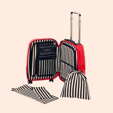 Sì, viaggiare. Con un trolley Lulu Guinness.