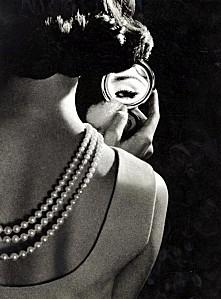 vintage-woman-with-pearls-looking-in-mirror.jpg