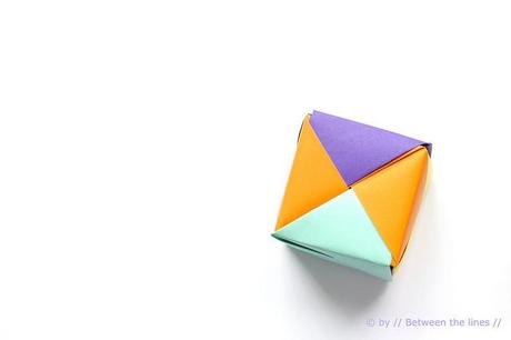 Origami paper cube and colors confetti