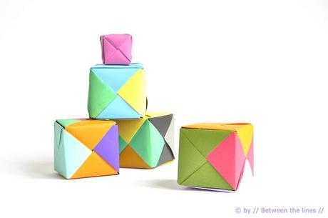 Origami paper cube and colors confetti