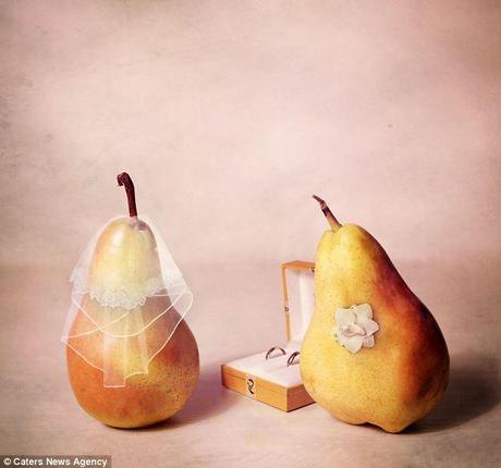Loved up pear: The fruit are pictured in a wedding scene complete with veil, corsage and wedding bands