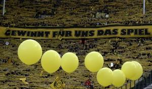 Supporters of Borussia Dortmund hold up