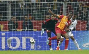 Galatasaray's Drogba scores a goal past Real Madrid's Varane and goalkeeper Lopez during their Champions League quarter-final second leg soccer match in Istanbul