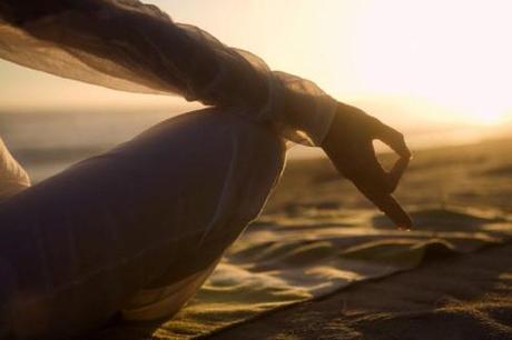 Woman Meditating on Beach