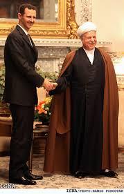 Il dittatore Bashar al Assad, ride e scherza con l'ex Presidente iraniano Rafsanjani
