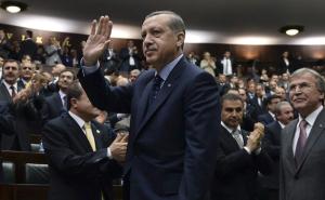 Turkey's PM Erdogan greets members of parliament from his ruling AK Party (AKP) during a meeting at the Turkish parliament in Ankara