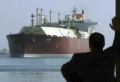 A man looks as the world's biggest Liquefied Natural Gas (LNG) tanker DUHAIL as she crosses through the Suez Canal