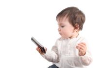 Casual baby watching a mobile phone