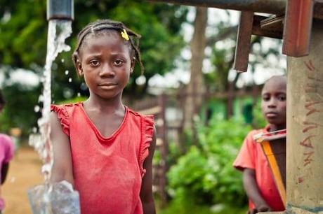 African little girl at water pump