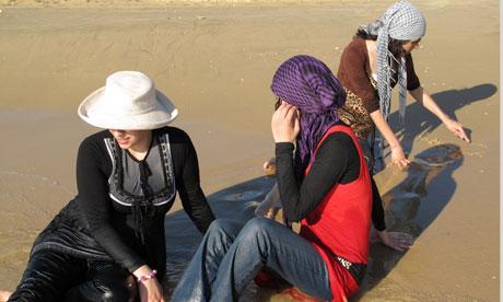 Women sit on a Tel Aviv beach. Palestinians need a permit to enter Israel
