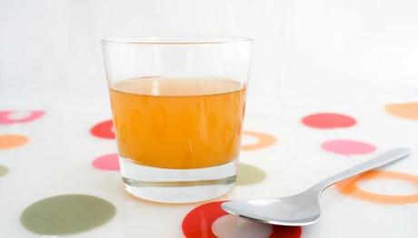 A glass of raw, unfiltered apple cider vinegar, with 