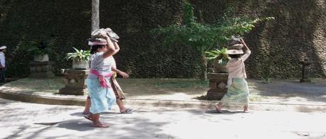 women carrying stones